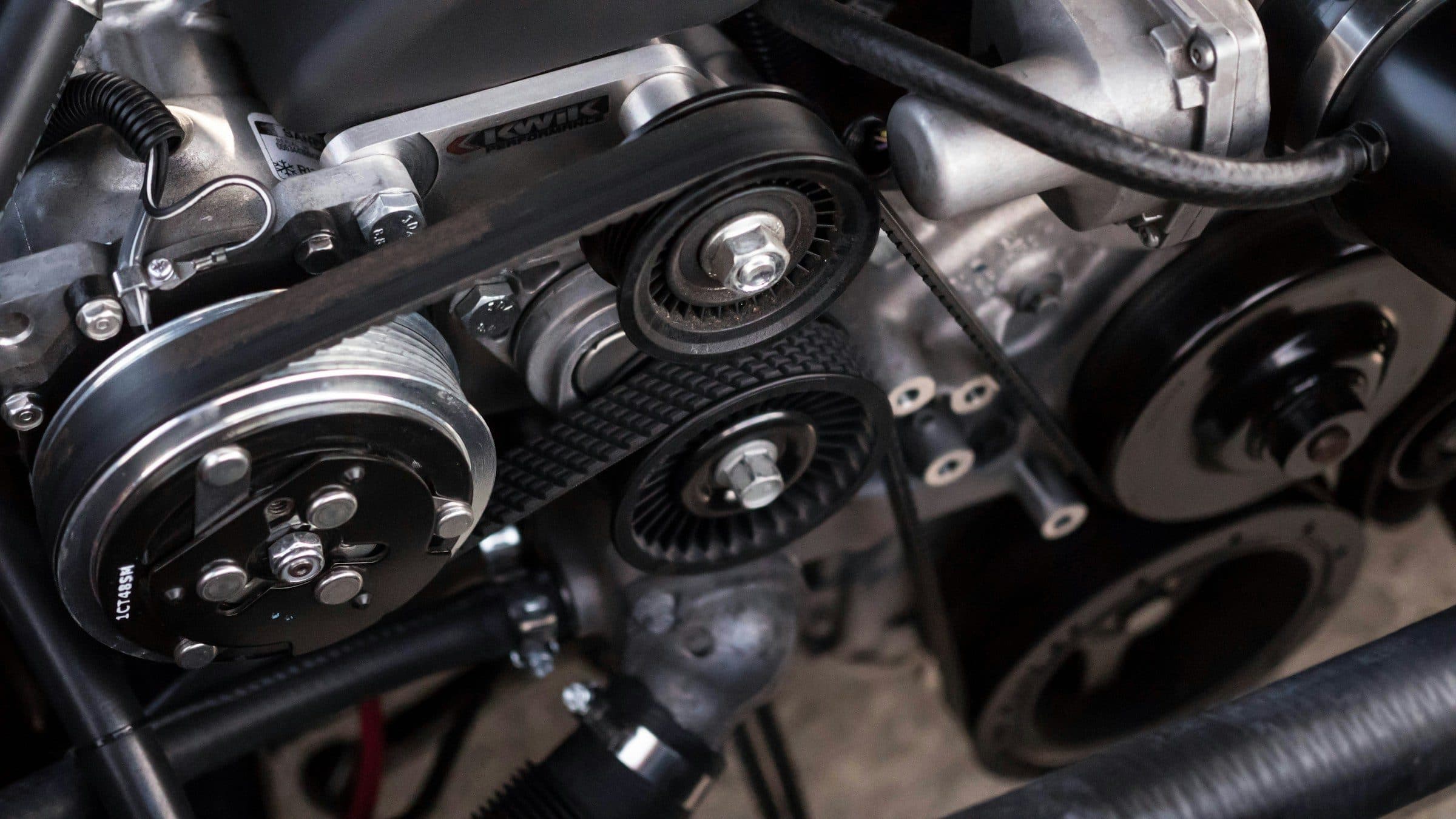 Close-up of a car engine in a dark workshop